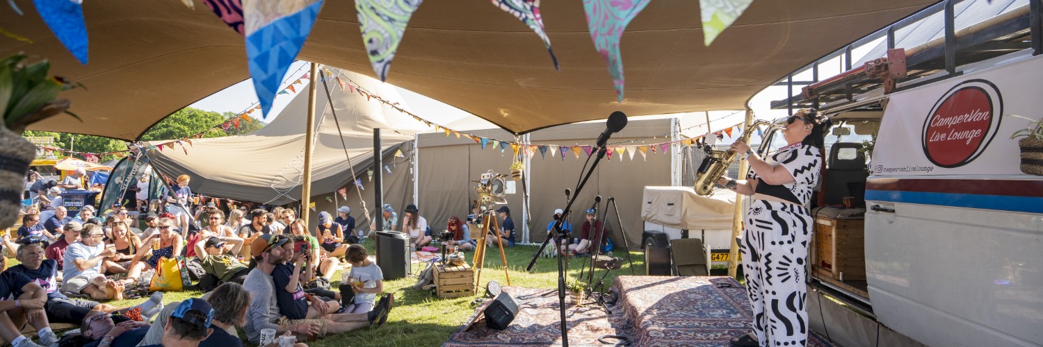 Live performer plays saxophone at the CamperVan Live Lounge at Keswick Mountain Festival in Keswick, Lake District